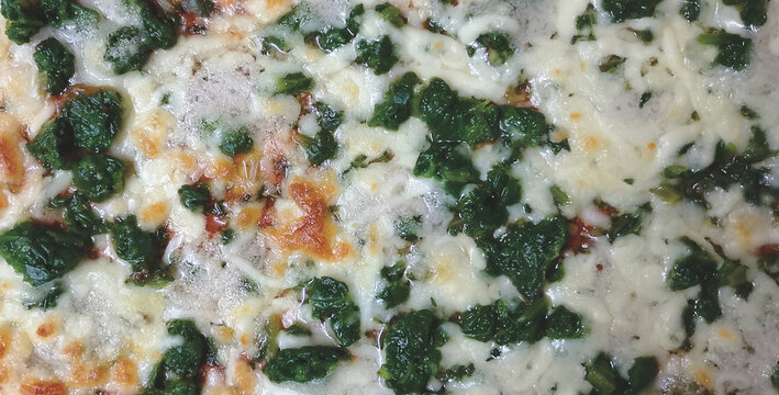 Zenith view of a spinach pizza.