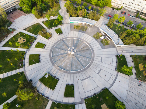 Aerial view of the circular fountain at Freedom Square surrounded by green lawns and paved walkways in Bratislava I, Bratislavsky kraj, Slovakia.