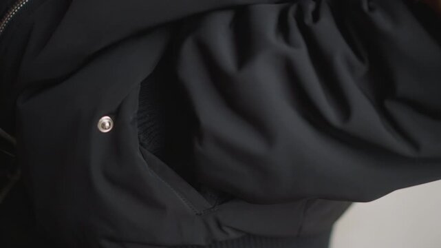 Rainy day moment captured vividly. Closeup of woman in rainy weather. Casual scene of woman with textured jacket outdoors. An intimate portrayal of woman with damp hair during rainy weather