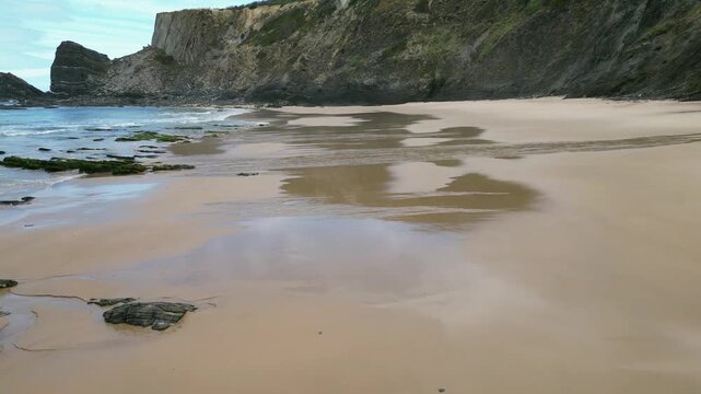 Aerial drone footage of Praia da Am&aacute;lia, Portugal: hidden beach, rugged cliffs and wild Atlantic coastline under natural light. Ideal for travel, nature and summer projects.
