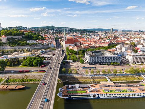Aerial view of St. Martin's Cathedral, the SNP Bridge with traffic, and a cruise ship on the Danube river in Bratislava, Bratislava Region, Slovakia.