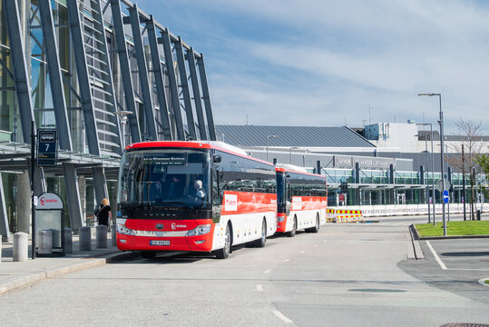 Stavanger Norway, May 3, 2026, Modern Boreal Flybussen electric airport shuttle buses parked at a terminal station, featuring zero-emission transport on a sunny day.