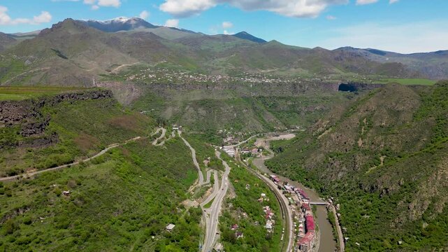 A scenic river gorge with steep cliffs and a winding river flowing through a mountainous landscape in northern Armenia.