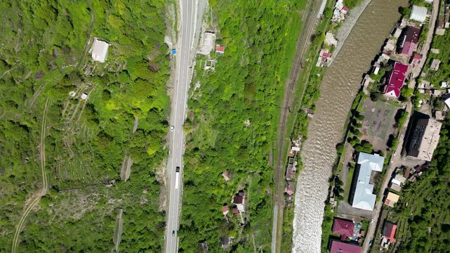 A scenic river gorge with steep cliffs and a winding river flowing through a mountainous landscape in northern Armenia.
