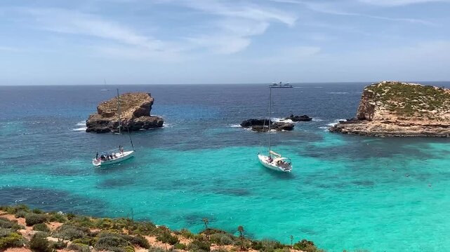White yacht stands in azure transparent water sea, beach Blue Lagoon Comino Malta.