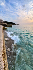 Fototapeta premium Adriatic coast Dobra Voda Montenegro with turquoise waves and pastel sky