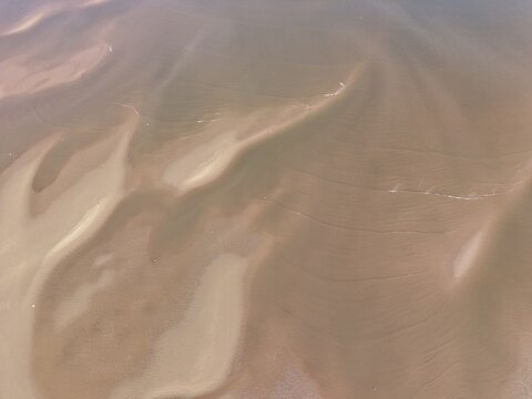 New Brighton Beach tidal pools forming across wet sand during low tide