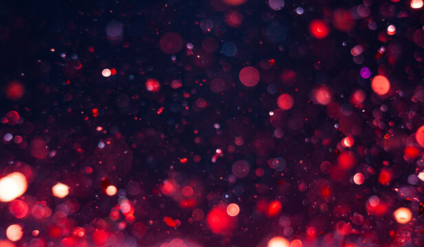 Bright red and purple sparkling lights create a festive atmosphere in the background