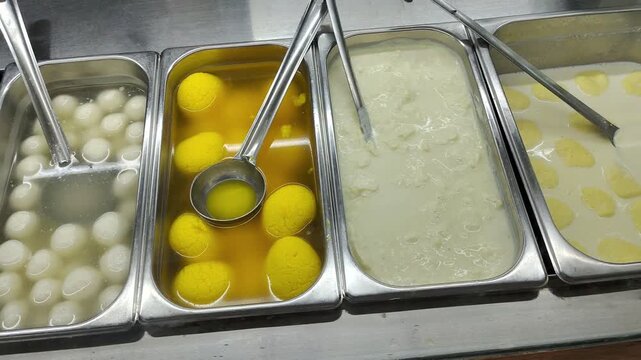 Fresh White Rasgullas and Yellow Rajbhog in Syrup Display