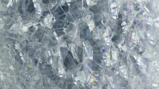 Close-up of Iridescent Soap Bubbles Shifting and Popping.
A high-detail macro shot of a dense cluster of soap bubbles. 