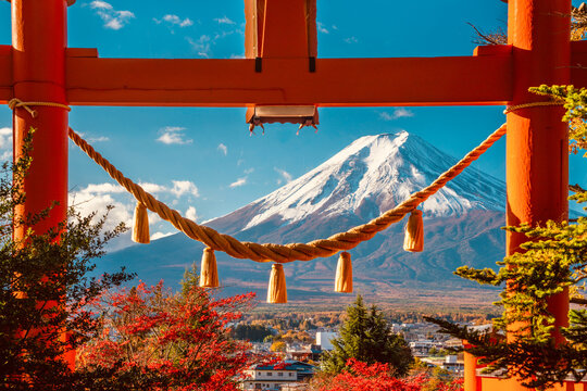 Mount Fuji framed by a red torii gate in Japan during autumn