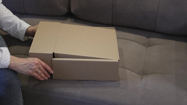Cardboard box. Close the box. Gift wrapping. Slow motion video. High quality 4k footage