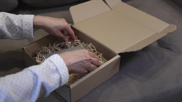 Cardboard box. Notebook. Slow motion video. High quality 4k footage