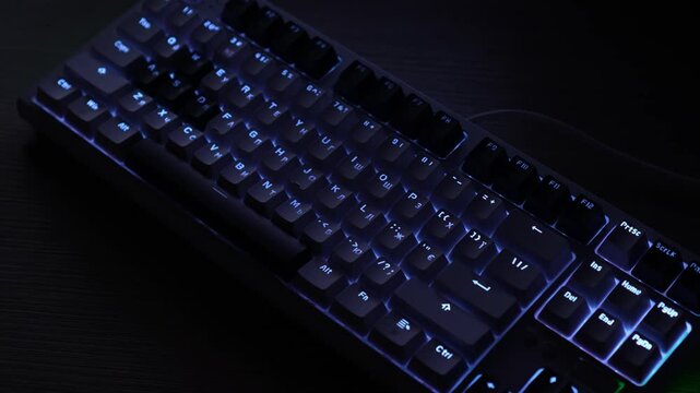 white custom keyboard with English and Ukrainian layout with pulsating backlight. dark night frame without light