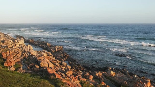 Rocky shoreline with waves and open ocean horizon, scenic coastal landscape representing natural beauty, travel destination and peaceful seaside environment