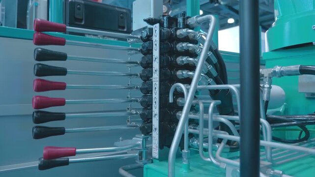 Hydraulic control unit with multiple levers on a truck lift at an exhibition. Shot in motion