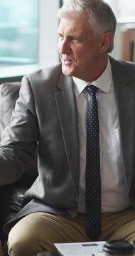 Mature, businessman and lawyer with clients or handshake for legal agreement, meeting or deal. Man, attorney or shaking hands with partners, documents or paperwork for advice, partnership or contract