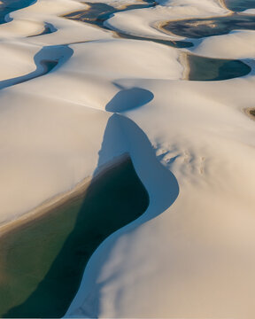 Aerial view of the white sand dunes and turquoise lagoons of Parque Nacional dos Lencois Maranhenses in Lencois Maranhenses, MA, Brazil.