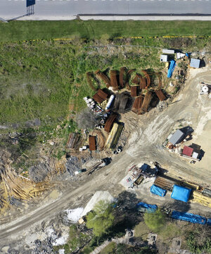 Aerial view of bundles of steel rebar, construction materials, and dirt tracks on a building site Avcilar, Istanbul, Turkiye.
