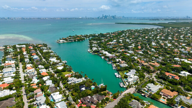 Aerial view of Key Biscayne Luxury Waterfront Paradise houses, with Miami Downtown in the background