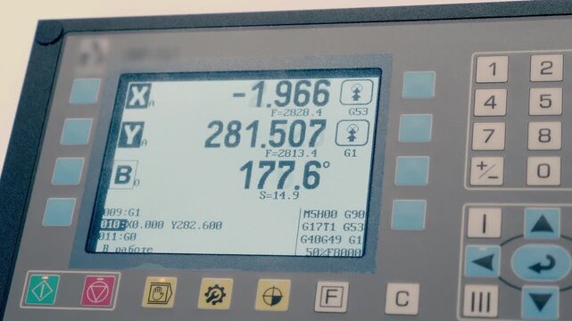A control panel with buttons and a monitor with changing numbers indicating the operation of the machine according to the program. Closeup