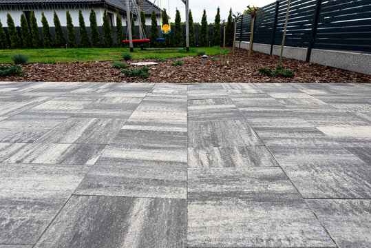 Uneven paving slabs showing subsidence in backyard