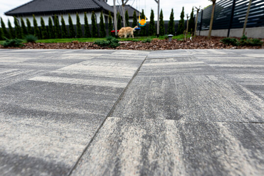 Uneven paving slabs showing significant subsidence in driveway
