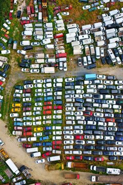 Aerial view of a large junkyard with rows of abandoned cars and vans parked on a grassy field Silivri, Istanbul, Turkey.