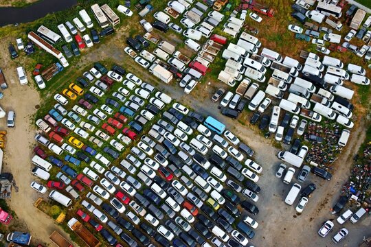 Aerial view of hundreds of colorful cars and white vans parked in dense rows at a large vehicle storage facility Silivri, Istanbul, Turkey.