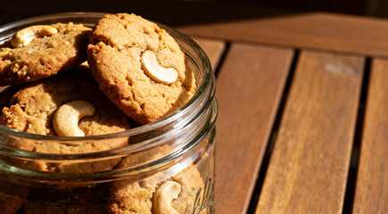 Fototapeta premium Sweet cashew cookies arranged in jar on table