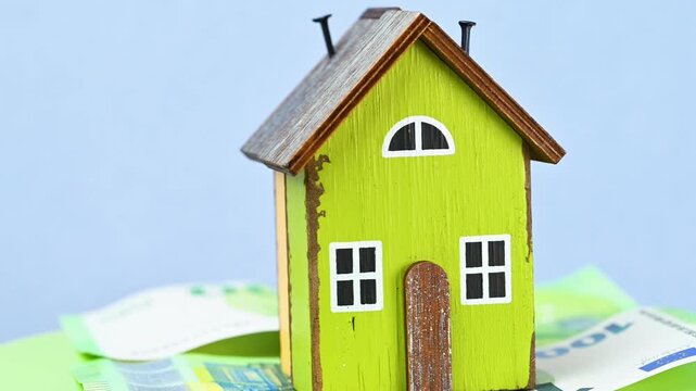 video of a wooden house with euro bills