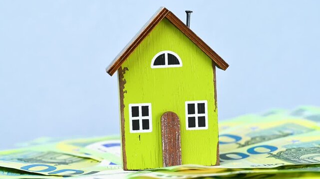video of a wooden house with euro bills