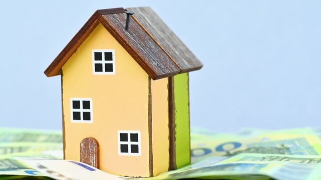 video of a wooden house with euro bills