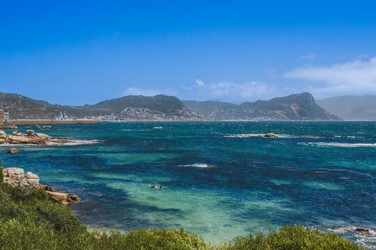 Turquoise coastal cove with rocky shore and mountain backdrop, Cape Peninsula, Western Cape