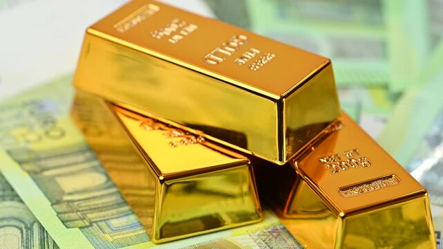 gold bars with euro bills