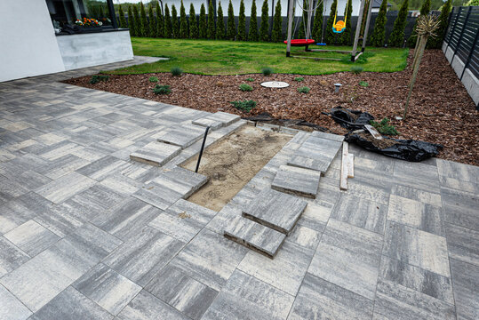 Removing paving slabs for patio renovation and repair