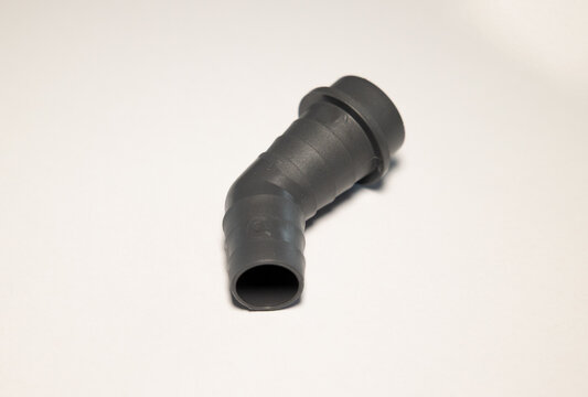 Drain adapter for washing machine or dishwasher hoses; for draining used water. White background; plastic; equipment; plumber.