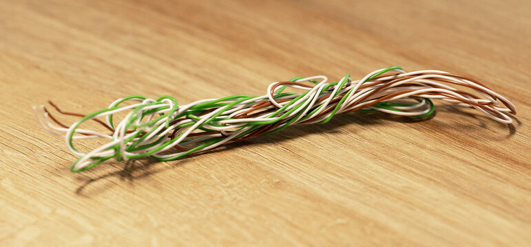Close-up knotted and intertwined wires of different colors on the table.