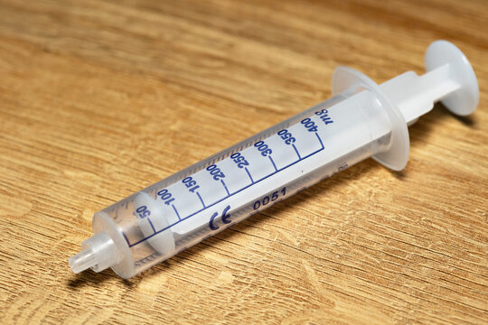 Close-up of the measuring scale on a plastic syringe without a needle. Injection, laboratory or medical equipment, infusion, hospital, health, medical application.