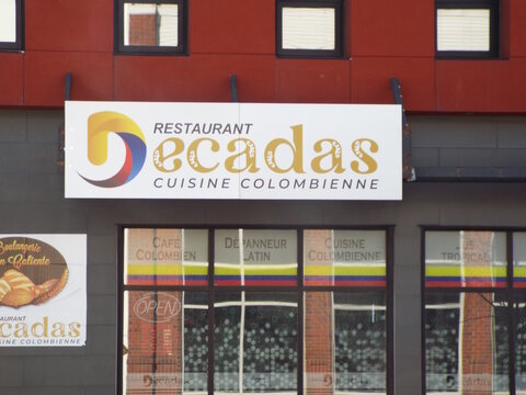 Gatineau, Quebec, Canada &ndash; April 19, 2026: The storefront of "Restaurant Decadas" features a large sign promoting authentic Colombian cuisine and a colorful Latin deli at 251 Boulevard Saint-Joseph.