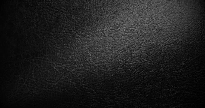 Close-up view of textured black leather surface for design use. 
