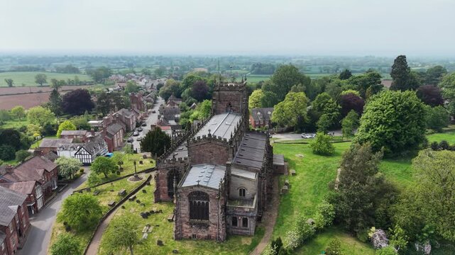 The stunning St Oswald&rsquo;s Church and surrounding Malpas village - drone slow rotate from rear, Cheshire, UK