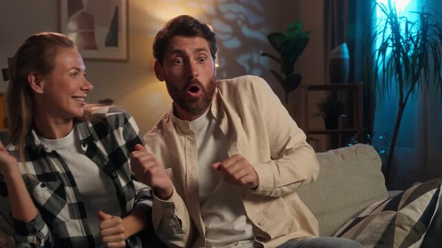 Happy family Caucasian middle-aged couple dancing at couch joyful cheerful adult woman with man dance funny positive spouses active moving having fun husband with wife fooling joy at evening home