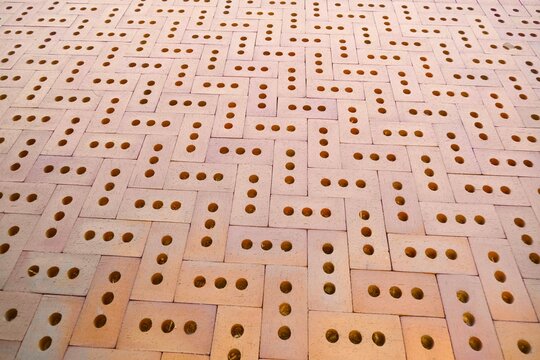 Perforated Brick Wall with Geometric Pattern and Repeating Holes