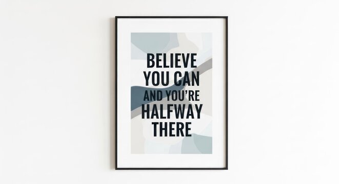 A framed motivational quote on a wall, featuring geometric shapes in muted tones. The text reads 'BELIEVE YOU CAN AND YOU'RE HALFWAY THERE'. 