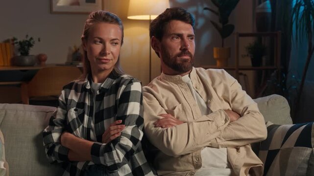 Caucasian family offended couple pushing shoulders misunderstanding quarrel sitting apart at couch adult wife husband spouses woman man quit silence after conflict jealous problem at evening home