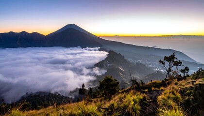Obraz premium Mountain peaks rise above a sea of clouds at sunrise, panoramic view