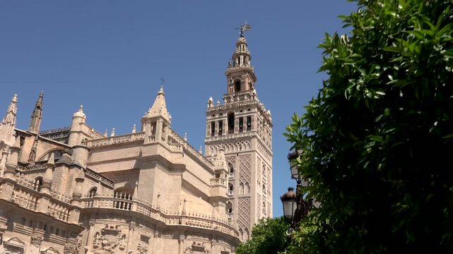 Authentic handheld 4K footage of the Giralda tower of Seville Cathedral filmed from street level in Seville Andalusia Spain