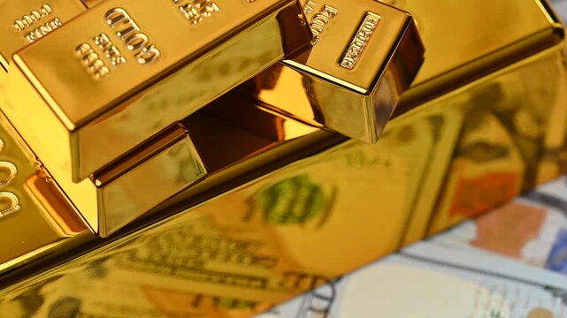 gold bars with dollar bills