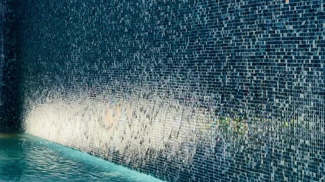 Modern luxury 5-star hotel resort swimming pool mosaic tile texture with night illumination light reflection in Sharm El Sheikh. Abstract architecture design of premium all inclusive villa in Egypt.